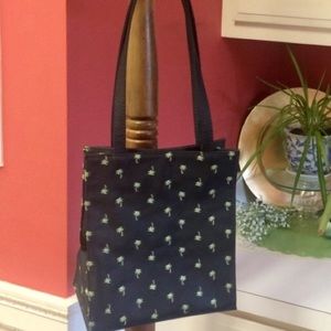 Black pocket book with palm trees